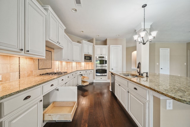 kitchen with white cabinetry, visible vents, dark wood-style flooring, a sink, and stainless steel appliances