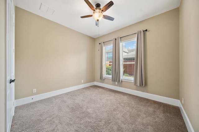 carpeted empty room featuring ceiling fan, baseboards, and visible vents