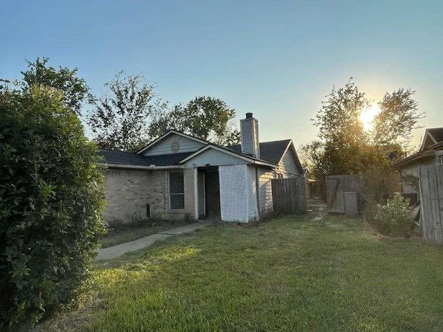 back house at dusk with a yard