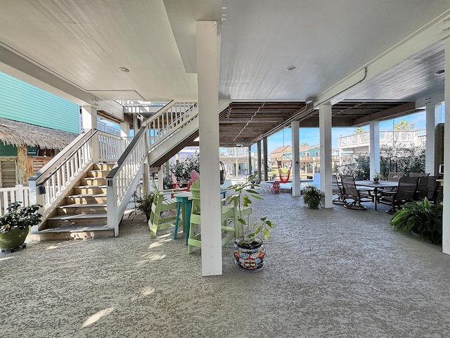 view of patio with outdoor dining space and stairway