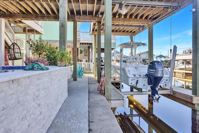 view of patio featuring a boat dock and boat lift