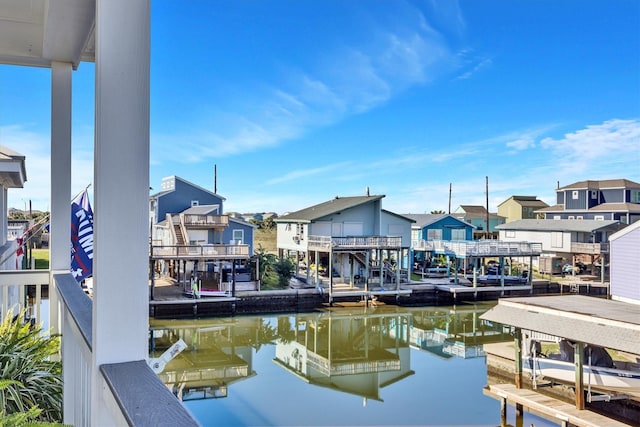 view of dock with a water view and a residential view