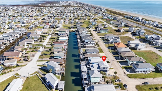 drone / aerial view featuring a water view and a view of the beach