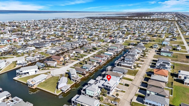 birds eye view of property with a water view and a residential view