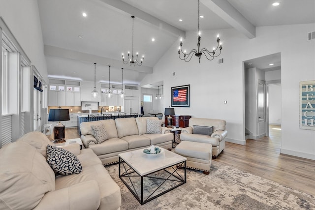 living area featuring beam ceiling, a chandelier, high vaulted ceiling, light wood-type flooring, and baseboards