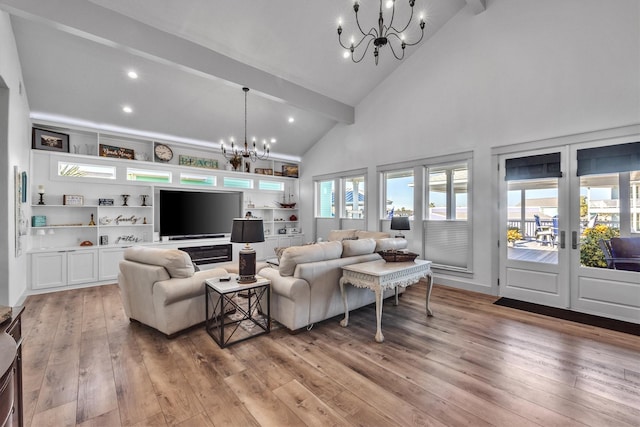 living area with beam ceiling, french doors, high vaulted ceiling, light wood-style floors, and a chandelier