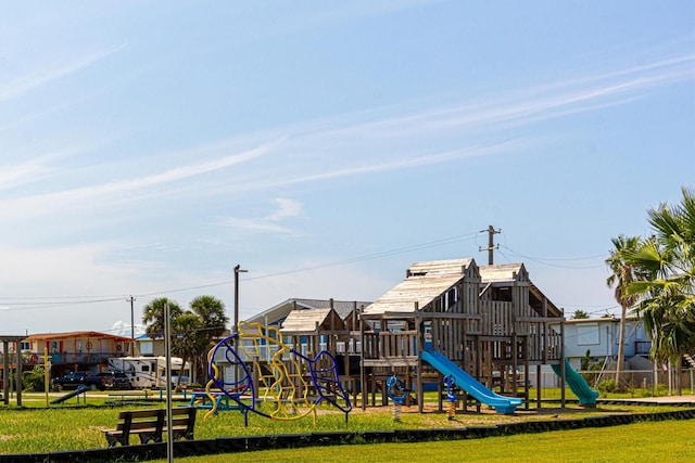 community jungle gym with a yard