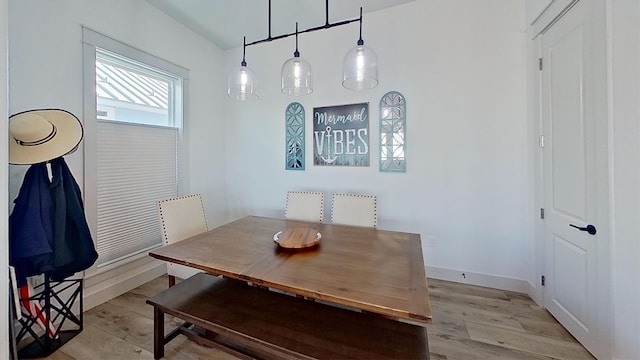 dining room with light wood-style floors and baseboards