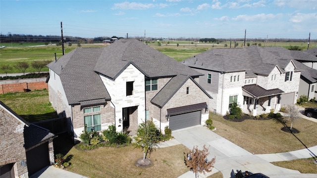 view of front of property with a garage and a front lawn