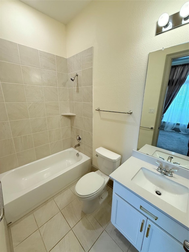 full bathroom with toilet, tile patterned flooring, tiled shower / bath, and vanity