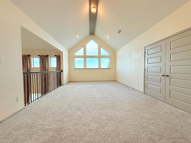 bonus room featuring light carpet and lofted ceiling with beams