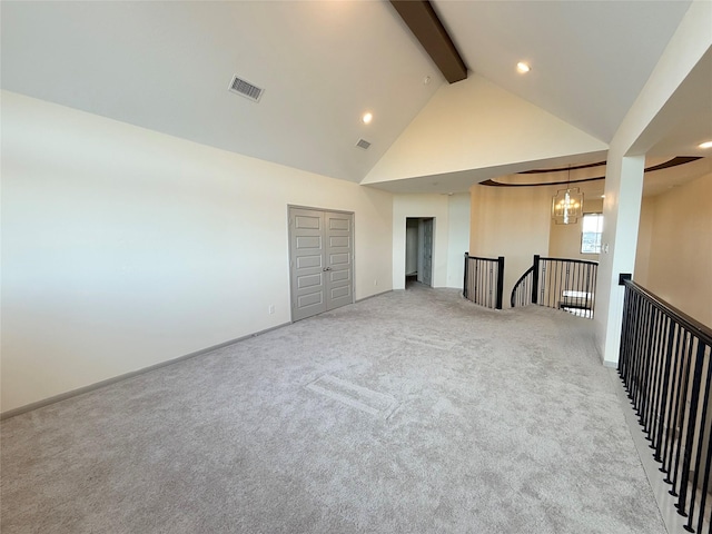 carpeted spare room featuring high vaulted ceiling, beam ceiling, and a chandelier