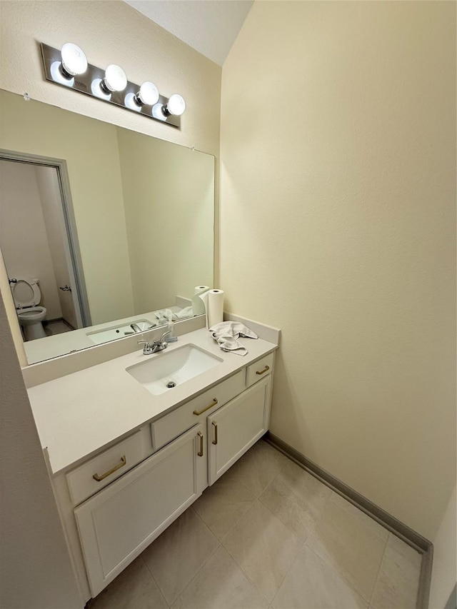 bathroom featuring toilet and vanity