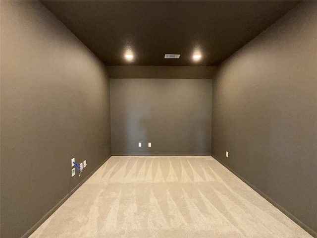 carpeted empty room with recessed lighting and visible vents