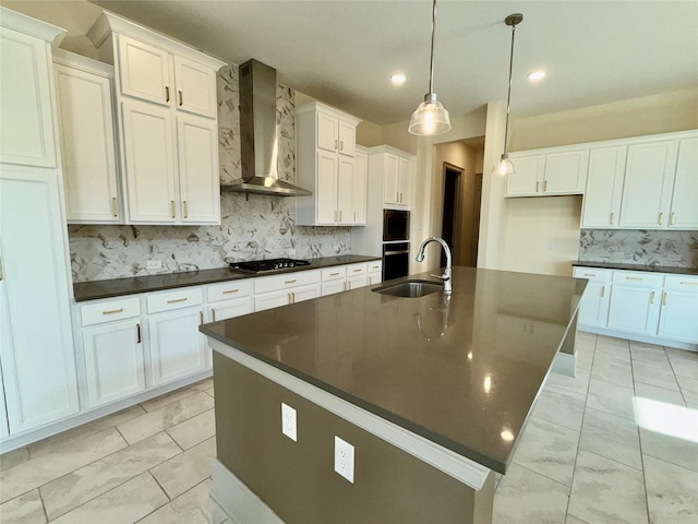 kitchen with marble finish floor, dark countertops, backsplash, a sink, and wall chimney exhaust hood