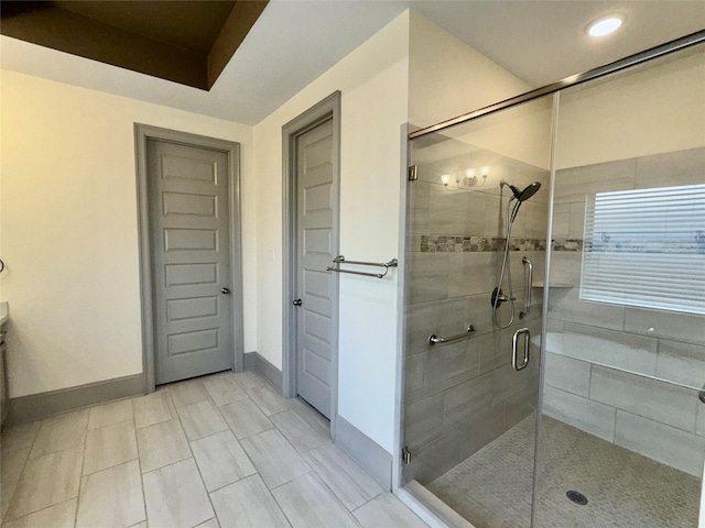 full bathroom featuring baseboards, recessed lighting, and a shower stall