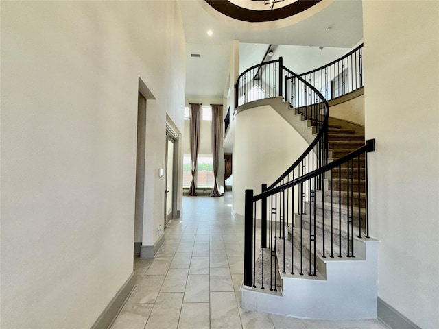 interior space featuring baseboards and a high ceiling