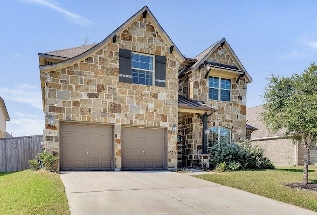 view of front facade with a garage and a front lawn