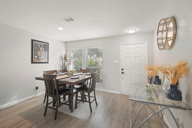 dining area featuring wood-type flooring