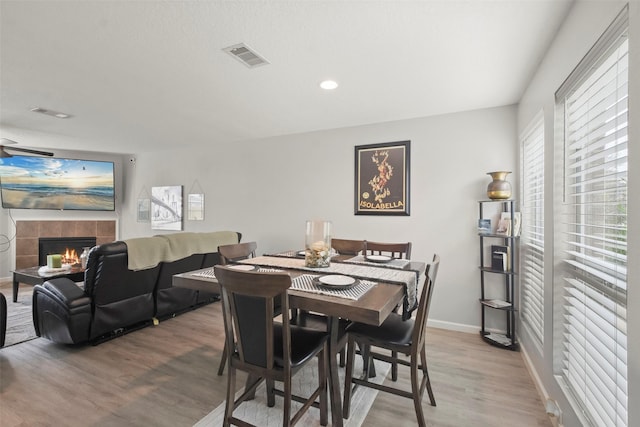 dining room with a fireplace and hardwood / wood-style flooring