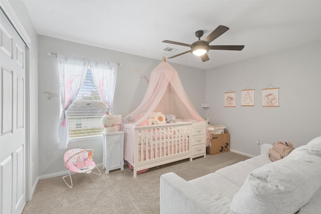 carpeted bedroom featuring ceiling fan and a closet