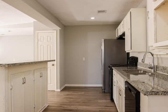 kitchen featuring dishwasher, dark wood-type flooring, white cabinetry, sink, and light stone counters