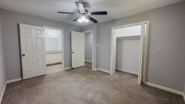 unfurnished bedroom with ceiling fan, a textured ceiling, a closet, and light carpet