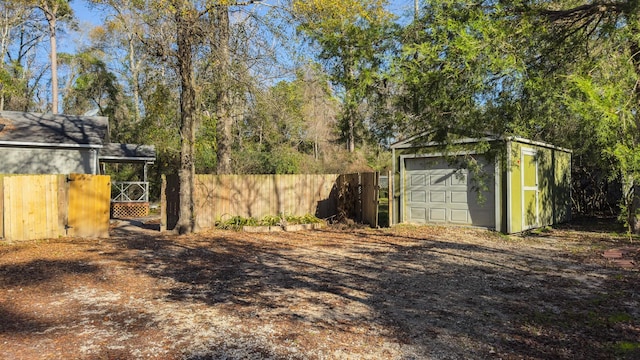 view of yard featuring a garage and an outdoor structure