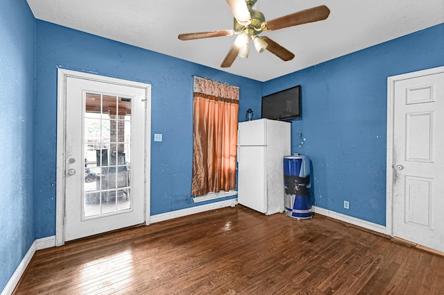 interior space featuring ceiling fan and dark wood-type flooring