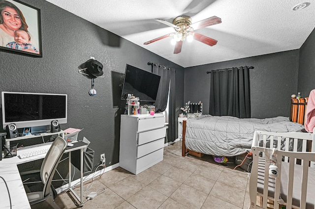 tiled bedroom featuring ceiling fan and a textured ceiling