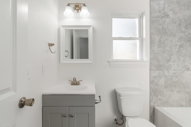 bathroom featuring toilet and vanity