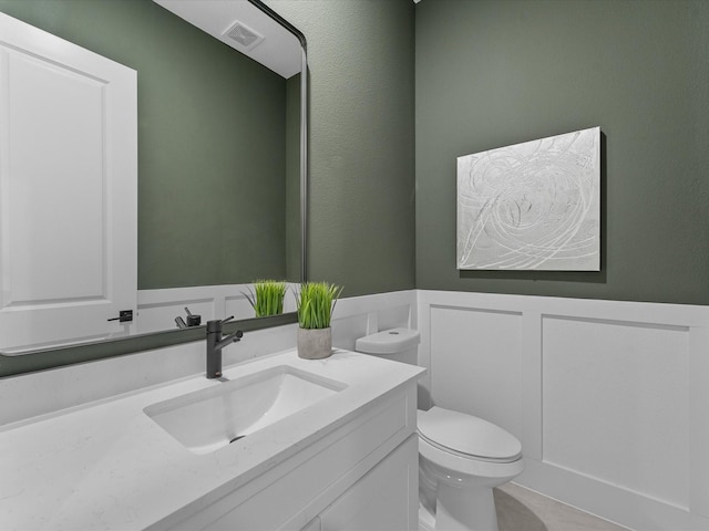 bathroom with tile patterned floors, toilet, and vanity