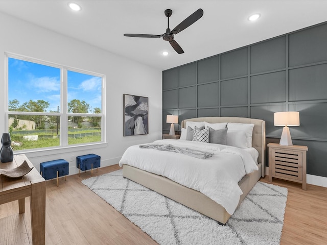 bedroom with ceiling fan and light hardwood / wood-style flooring