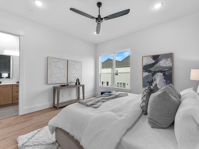 bedroom with ceiling fan, light hardwood / wood-style floors, and ensuite bath