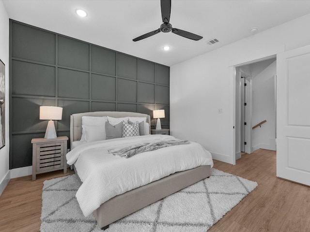 bedroom with ceiling fan and light wood-type flooring