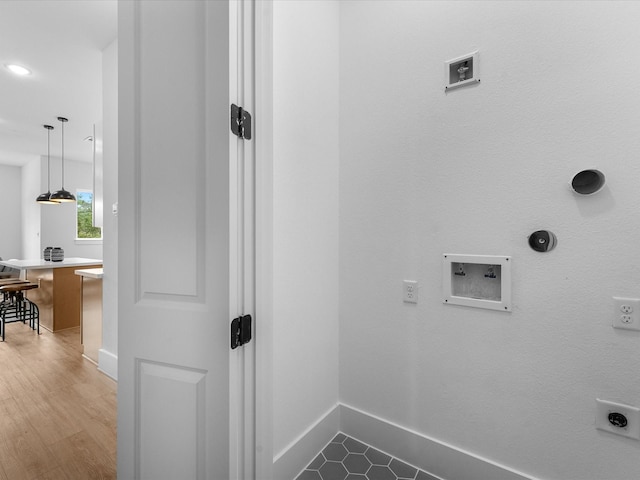 laundry area featuring gas dryer hookup, hookup for an electric dryer, hookup for a washing machine, and hardwood / wood-style flooring