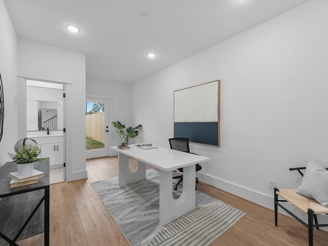 office area with light hardwood / wood-style floors