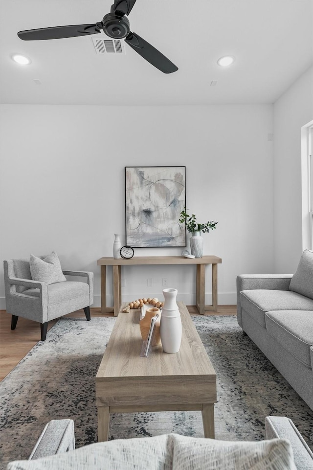 living room featuring hardwood / wood-style flooring and ceiling fan