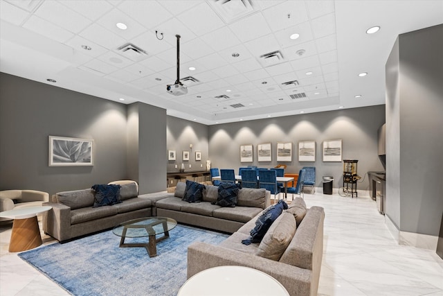 living room featuring a paneled ceiling