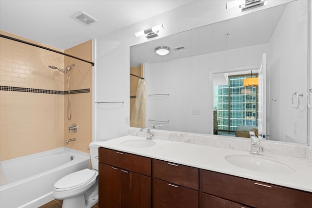 full bathroom featuring toilet, vanity, and shower / bathtub combination with curtain