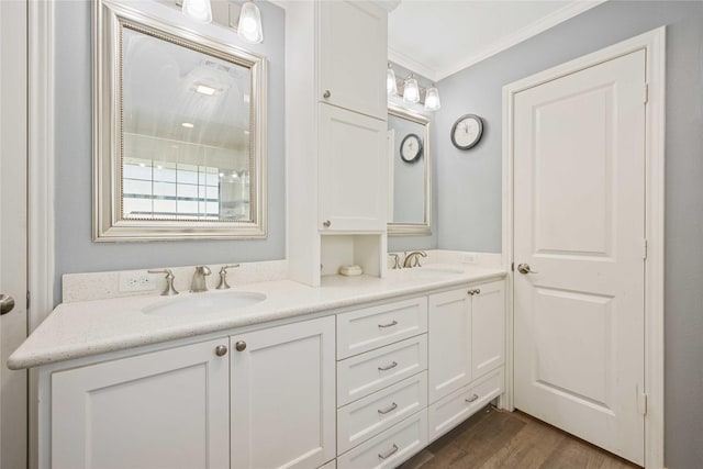 bathroom featuring wood-type flooring, vanity, and crown molding