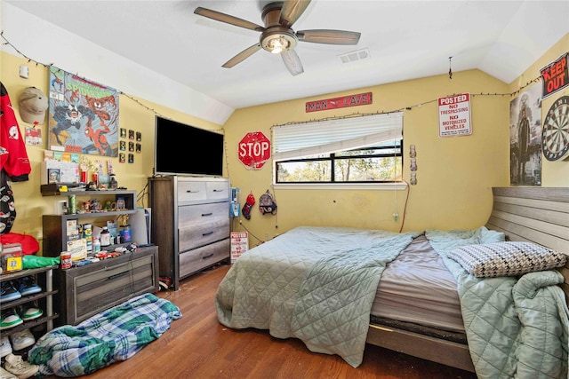 bedroom featuring ceiling fan, wood-type flooring, and lofted ceiling