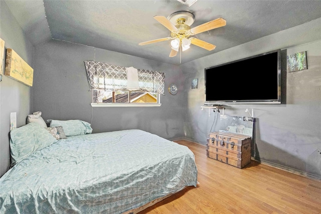 bedroom with ceiling fan and hardwood / wood-style flooring