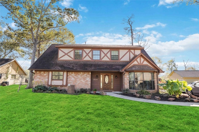 tudor-style house with a front yard