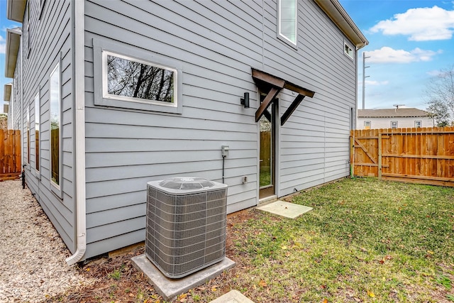 exterior space featuring cooling unit and a yard