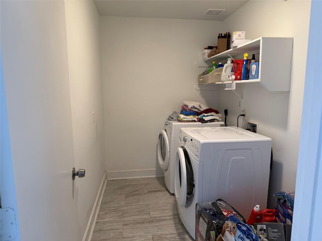 washroom with washing machine and clothes dryer