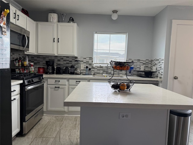 kitchen featuring white cabinetry, appliances with stainless steel finishes, and a center island