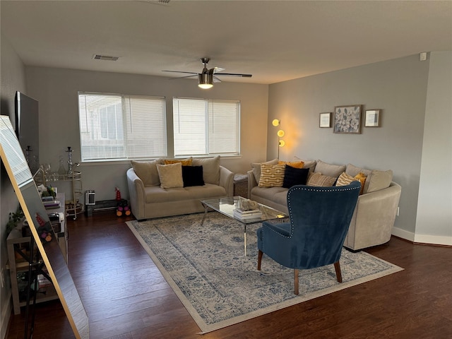 living room with ceiling fan and dark wood-type flooring