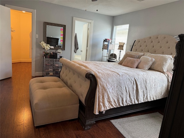 bedroom with ensuite bath and hardwood / wood-style floors