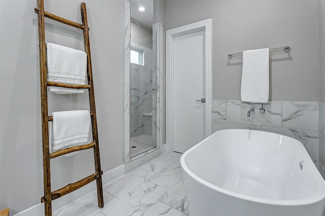 bathroom featuring shower with separate bathtub